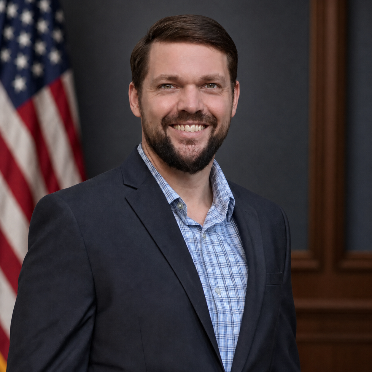 Blake Kamoroff, civilian military defense attorney, in a professional office with a U.S. flag